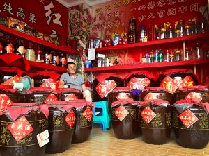 A shop full of baijiu aging in clay urns